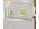 Vaulted main bedroom with carpet, natural light, and wood door at 6310 W Sumac Ave, Littleton, CO 80123