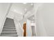 Bright foyer showcases a carpeted staircase with white railings and trim at 6310 W Sumac Ave, Littleton, CO 80123