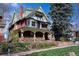 Charming Victorian home showcasing intricate architectural details, a covered porch, and a well-manicured lawn at 1435 Vine St # 5, Denver, CO 80206