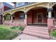 Inviting front porch with decorative pillars, a beautiful wood door, and a cozy, classic curb appeal at 1435 Vine St # 5, Denver, CO 80206