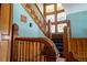 Ornate wooden staircase featuring beautifully carved banisters and a stained glass window, adding unique charm at 1435 Vine St # 5, Denver, CO 80206