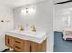 Modern bathroom featuring a double sink vanity, wood cabinets and textured tile backsplash at 8331 Oakwood St, Westminster, CO 80031