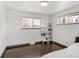 Bright bedroom with dark wood floors, built-in shelving, and windows letting in ample natural light at 8331 Oakwood St, Westminster, CO 80031