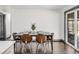 Well-lit dining area featuring a wooden table set for four, with stylish chairs and dark wood floors at 8331 Oakwood St, Westminster, CO 80031