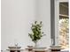 Close-up on a dining table with four place settings, showing plates, glasses, and a plant centerpiece at 8331 Oakwood St, Westminster, CO 80031