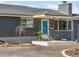 Close-up of the front entrance, showcasing a teal front door and gray brick exterior at 8331 Oakwood St, Westminster, CO 80031