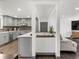 Bright, open concept kitchen with gray cabinets, an island, and stylish backsplash at 8331 Oakwood St, Westminster, CO 80031