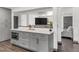 Kitchen island bar with seating and adjacent living area at 8331 Oakwood St, Westminster, CO 80031