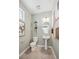 Half bathroom with pedestal sink, toilet, and wall decor at 940 Andrews Crest Dr, Berthoud, CO 80513