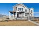 Charming gray two-story home with stylish architectural detail, covered porch, and manicured lawn at 940 Andrews Crest Dr, Berthoud, CO 80513