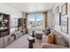 Cozy living room with large windows, comfortable seating, and custom cabinets at 940 Andrews Crest Dr, Berthoud, CO 80513