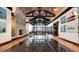 Grand lobby featuring a stone fireplace, striking chandelier, vaulted ceilings, and large windows with beautiful outside views at 940 Andrews Crest Dr, Berthoud, CO 80513