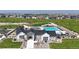 Aerial view of community pool, clubhouse, playground, and landscaped green spaces at 940 Andrews Crest Dr, Berthoud, CO 80513