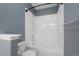 Bathroom showcasing a soaking tub, white tile, and a showerhead for a relaxing experience at 15700 E Jamison Dr # 3-307, Englewood, CO 80112