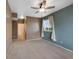 Neutral bedroom with a ceiling fan, carpet, and a door leading to the bathroom at 15700 E Jamison Dr # 3-307, Englewood, CO 80112