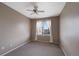 Bedroom featuring neutral carpet, a ceiling fan, and a window with sheer curtains at 15700 E Jamison Dr # 3-307, Englewood, CO 80112