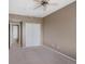 Bedroom boasting neutral carpet, a ceiling fan, and a closet with sliding doors at 15700 E Jamison Dr # 3-307, Englewood, CO 80112