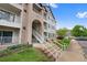 Exterior of a three-story condo showing walkways leading to unit front doors and balconies at 15700 E Jamison Dr # 3-307, Englewood, CO 80112