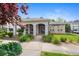 Clubhouse showing lush landscaping around a brick building with a covered entrance and ample parking at 15700 E Jamison Dr # 3-307, Englewood, CO 80112