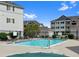 Community pool surrounded by well-maintained buildings with lounge chairs ready for summer enjoyment at 15700 E Jamison Dr # 3-307, Englewood, CO 80112