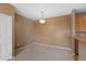 Dining room with neutral walls, carpeted floors, and a modern lighting fixture at 15700 E Jamison Dr # 3-307, Englewood, CO 80112