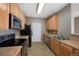 Functional kitchen features essential appliances, wood cabinetry, and neutral countertops at 15700 E Jamison Dr # 3-307, Englewood, CO 80112