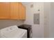 Convenient laundry room with washer, dryer, and upper cabinets for storage at 15700 E Jamison Dr # 3-307, Englewood, CO 80112