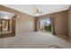 Spacious living room with neutral walls, carpeted floors, and a patio door leading to an outdoor balcony at 15700 E Jamison Dr # 3-307, Englewood, CO 80112