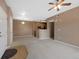 Open floor plan of the living room and kitchen with neutral walls and carpeted floors at 15700 E Jamison Dr # 3-307, Englewood, CO 80112