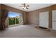 Living room with neutral walls, carpeted floors, and a patio door leading to an outdoor balcony at 15700 E Jamison Dr # 3-307, Englewood, CO 80112