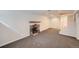 Spacious basement area with stone fireplace, carpet, and access to the stairs at 1650 Locust St, Denver, CO 80220