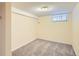 Cozy bedroom with neutral walls, carpet, and a small window for natural light at 1650 Locust St, Denver, CO 80220