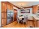 Charming breakfast nook featuring custom cabinets, stainless fridge and eat-in table at 1650 Locust St, Denver, CO 80220