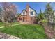 Lovely front yard featuring a brick Tudor-style home with manicured lawn at 1650 Locust St, Denver, CO 80220