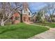 Landscaped front yard with walkway leading to Tudor-style home at 1650 Locust St, Denver, CO 80220
