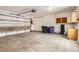 Organized garage with storage cabinets, overhead door, and concrete floors at 1650 Locust St, Denver, CO 80220
