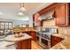 Kitchen with granite countertops, wooden cabinets, and island at 1650 Locust St, Denver, CO 80220