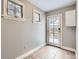 Laundry room with tile floor, back door, and white cabinets at 1650 Locust St, Denver, CO 80220