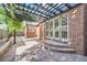 Brick patio with pergola offering outdoor seating and access to the home's interior at 1650 Locust St, Denver, CO 80220