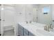 Bright bathroom featuring dual sinks with granite countertops, modern fixtures and a large soaking tub at 434 N Old Hammer St, Aurora, CO 80018