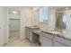 Bright bathroom featuring dual sinks with granite countertops, modern fixtures and a large walk-in closet at 434 N Old Hammer St, Aurora, CO 80018