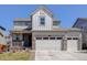 Charming two-story home with a three-car garage and stone accents at 434 N Old Hammer St, Aurora, CO 80018