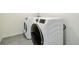 Modern laundry room with front load washer and dryer with bright white finish at 434 N Old Hammer St, Aurora, CO 80018