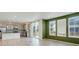 Bright living space flows to a kitchen with gray cabinets and stainless appliances near large windows at 434 N Old Hammer St, Aurora, CO 80018