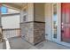 Inviting porch with stone accents and a view of the home's entrance at 434 N Old Hammer St, Aurora, CO 80018