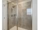 The tiled walk-in shower features a glass door and modern showerhead at 434 N Old Hammer St, Aurora, CO 80018