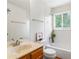 Bright bathroom with a tiled shower, vanity and natural light from a large window at 101 S Downing St # 8, Denver, CO 80209