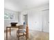 Bright bedroom with carpet, simple desk, chair, vintage typewriter, and a large window overlooking the neighborhood at 101 S Downing St # 8, Denver, CO 80209