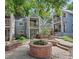 Inviting townhome community space with a brick planter, steps, and lush landscaping at 101 S Downing St # 8, Denver, CO 80209