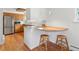Efficient kitchen with breakfast bar, stainless steel refrigerator, and ample cabinet space at 101 S Downing St # 8, Denver, CO 80209